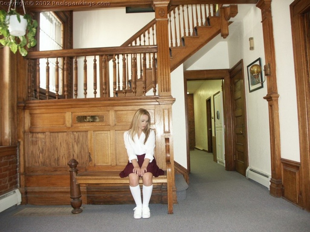 A naughty schoolgirl waits to see the Dean.